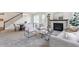 Bright living room features fireplace, shelving, modern furniture, and an adjacent dining area at 7367 S Pennsylvania St, Littleton, CO 80122