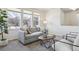 Bright living room featuring a comfortable sofa, stylish decor, and large windows offering picturesque views at 7367 S Pennsylvania St, Littleton, CO 80122