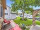 Cozy backyard with a red deck, a small table set, and a view of the surrounding neighborhood at 9150 Garrison St, Broomfield, CO 80021