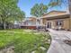 Spacious backyard features a well-maintained lawn, deck, patio, hot tub, and mature trees at 9150 Garrison St, Broomfield, CO 80021