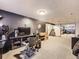 Basement features a TV, stairs, and neutral carpet at 9150 Garrison St, Broomfield, CO 80021