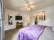 Bedroom features a large bed with a purple cover, a ceiling fan, and a pass through to the bathroom at 9150 Garrison St, Broomfield, CO 80021