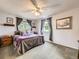 Bedroom featuring two windows with curtains, a bed with a gray blanket, and a ceiling fan at 9150 Garrison St, Broomfield, CO 80021