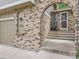 Inviting home entrance with brick archway, house number, and steps leading to the front door at 9150 Garrison St, Broomfield, CO 80021