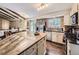 Modern kitchen with granite countertops, stainless steel appliances, and white cabinetry at 9150 Garrison St, Broomfield, CO 80021