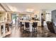 Open-concept kitchen with a large island, bar stools, and seamless flow to the dining area at 9150 Garrison St, Broomfield, CO 80021