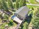 Aerial view of a house with a beautiful deck, perfectly nestled among trees and unique rock formations at 22155 Cook Ln, Morrison, CO 80465