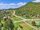 Expansive aerial shot showcasing the property's vast land, surrounding greenery, and tranquil environment at 22155 Cook Ln, Morrison, CO 80465
