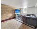 Basement featuring a grey sectional sofa, a large television, and a decorative area rug at 22155 Cook Ln, Morrison, CO 80465