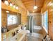Bathroom with wood paneled walls, tub, and vanity at 22155 Cook Ln, Morrison, CO 80465