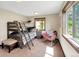 Bedroom with bunk beds, a chair, two windows letting in natural light, and a small night stand at 22155 Cook Ln, Morrison, CO 80465