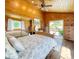 Bright bedroom featuring wood paneled walls, ceiling fan, sliding glass doors, and a large closet at 22155 Cook Ln, Morrison, CO 80465