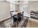 Dining area with wooden table, four chairs, and a decorative rug plus a display shelf at 22155 Cook Ln, Morrison, CO 80465