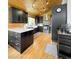 Modern kitchen with black cabinets, stainless steel appliances, and wood ceilings at 22155 Cook Ln, Morrison, CO 80465