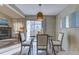 Bright dining area with glass table and kitchen view at 3813 E 121St Ave, Thornton, CO 80241