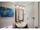 Small bathroom with sink, mirror, and toilet at 6403 Zang Ct, Arvada, CO 80004