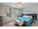 Bedroom with teal bedding and bench at foot of bed at 6403 Zang Ct, Arvada, CO 80004