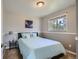 Guest bedroom with light blue bedding and wood dresser at 6403 Zang Ct, Arvada, CO 80004