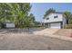 Two-story home with a gray and white exterior and landscaped yard at 6403 Zang Ct, Arvada, CO 80004