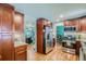 Modern kitchen with stainless steel appliances and wooden cabinetry at 6403 Zang Ct, Arvada, CO 80004