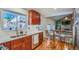 Updated kitchen with wooden cabinets, stainless steel appliances, and a breakfast bar at 6403 Zang Ct, Arvada, CO 80004