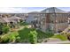 Home's backyard features large grassy yard and custom deck with stone accents at 7606 S Valleyhead Ct, Aurora, CO 80016