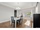 Open-concept dining area with hardwood floors and chandelier at 7606 S Valleyhead Ct, Aurora, CO 80016