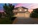 Two story home with an attached three car garage, lawn, and mature trees at 7606 S Valleyhead Ct, Aurora, CO 80016