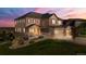 Beautiful two-story home with a three car garage and a covered porch at 7606 S Valleyhead Ct, Aurora, CO 80016
