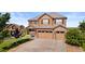 Beautiful two-story home with a three-car garage, stone accents, and a well-manicured lawn, perfect for Gathering living at 7606 S Valleyhead Ct, Aurora, CO 80016