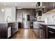 Gourmet kitchen boasts stainless steel appliances, granite counters, and ample dark wood cabinetry at 7606 S Valleyhead Ct, Aurora, CO 80016