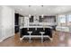 Open kitchen features a large island with seating, pendant lighting, and adjacent breakfast nook at 7606 S Valleyhead Ct, Aurora, CO 80016