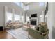 Sun-filled living room features a stone fireplace, a large flat-screen television, and stylish decor at 7606 S Valleyhead Ct, Aurora, CO 80016