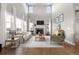 Bright living room with soaring ceilings, fireplace, large windows, and hardwood floors at 7606 S Valleyhead Ct, Aurora, CO 80016