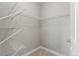 Spacious walk-in closet featuring wire shelving and neutral carpeting at 7606 S Valleyhead Ct, Aurora, CO 80016