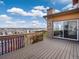 Large back deck with stone accents, featuring neighborhood views and sliding glass door access to the house at 14710 Domino Dr, Parker, CO 80134