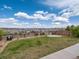 Well-maintained back yard features a lawn area and a stone patio, enclosed by a wood fence at 14710 Domino Dr, Parker, CO 80134