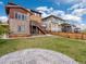 Backyard with patio, lawn, and wooden fence, offers a cozy outdoor living space at 14710 Domino Dr, Parker, CO 80134