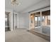 Basement area with carpet, sliding glass door to patio, and nearby bathroom with tiled shower at 14710 Domino Dr, Parker, CO 80134
