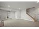 Spacious finished basement with modern staircase and neutral decor is ready to be enjoyed at 14710 Domino Dr, Parker, CO 80134
