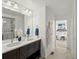 Bathroom boasts a double sink vanity, walk-in shower and tasteful decor with convenient access to the bedroom at 14710 Domino Dr, Parker, CO 80134