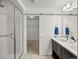 Bathroom features a walk-in shower, double sink vanity, and sliding door leading to walk-in closet at 14710 Domino Dr, Parker, CO 80134