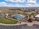 Aerial view of the community pool, playground, and green spaces, offering recreational opportunities at 14710 Domino Dr, Parker, CO 80134