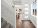 Welcoming entryway with modern door, hardwood floors, and staircase at 14710 Domino Dr, Parker, CO 80134
