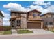 Beautiful two-story home with a two car garage, stone accents and manicured lawn at 14710 Domino Dr, Parker, CO 80134