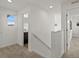 Upstairs hallway with neutral carpet leads to a bright bathroom and bedroom at 14710 Domino Dr, Parker, CO 80134
