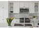 Bright kitchen with white cabinets, stainless steel appliances, and stylish backsplash at 14710 Domino Dr, Parker, CO 80134