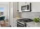 Modern kitchen with stainless steel appliances and white cabinets; breakfast nook is visible at 14710 Domino Dr, Parker, CO 80134
