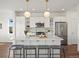 Bright kitchen features a large island with seating, pendant lighting, and stainless steel appliances at 14710 Domino Dr, Parker, CO 80134
