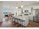 Modern kitchen with stainless steel appliances, white cabinets, and a spacious island with seating at 14710 Domino Dr, Parker, CO 80134